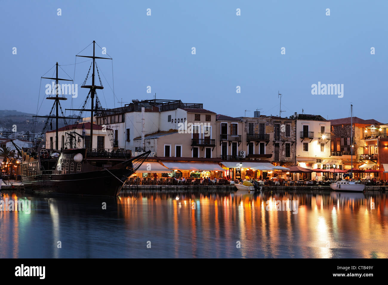 Old venetian port with clipper ship in the evening, Rethymnon, Crete, Greece Stock Photo