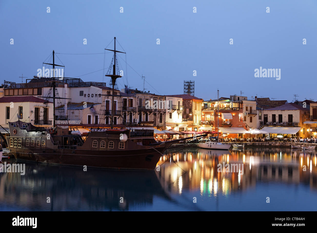 Old venetian port with clipper ship in the evening, Rethymnon, Crete, Greece Stock Photo