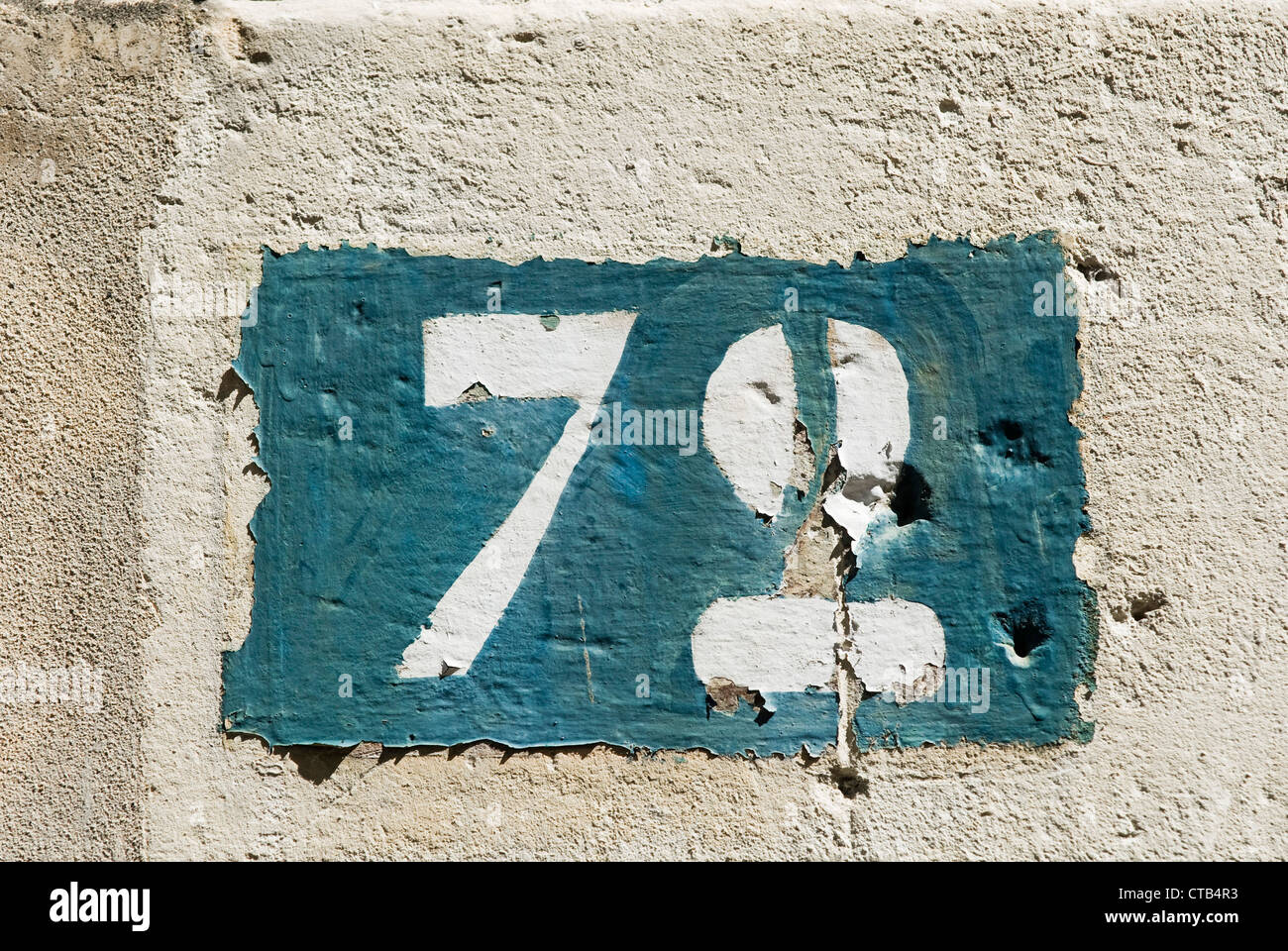 Number Seventy Two, No.72, #72, painted stencil on house wall - France. Stock Photo