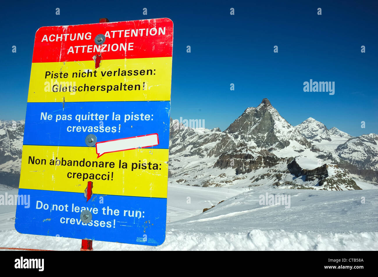Warning leaving marked protected piste Do not leave run crevassses! against mountain background Matterhorn Zermatt Swiss) Stock Photo