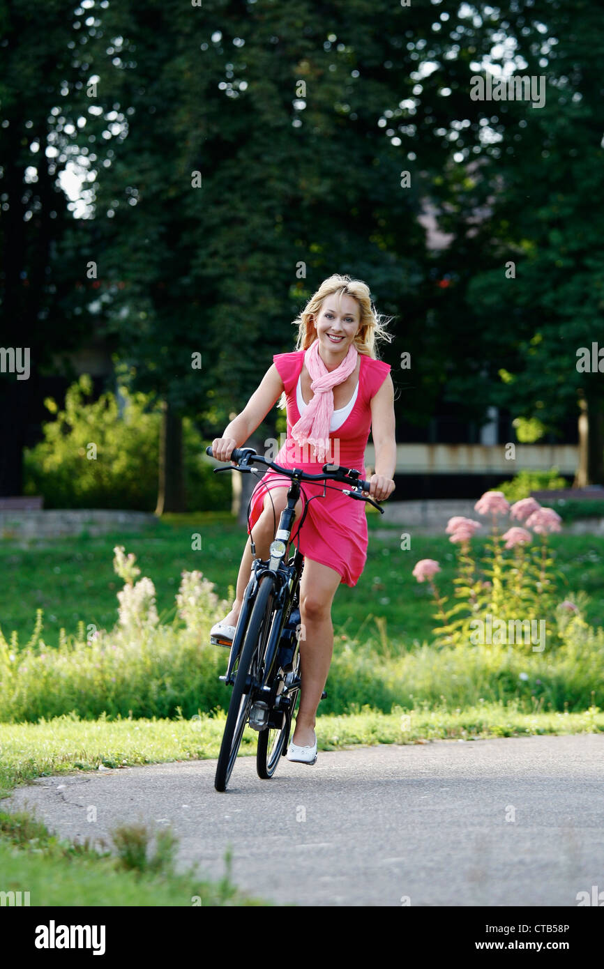 Woman cycling through Rosenstein Park on an e-bike, bike tour, Rosenstein Park, Stuttgart, Baden-Wurttemberg, Germany Stock Photo