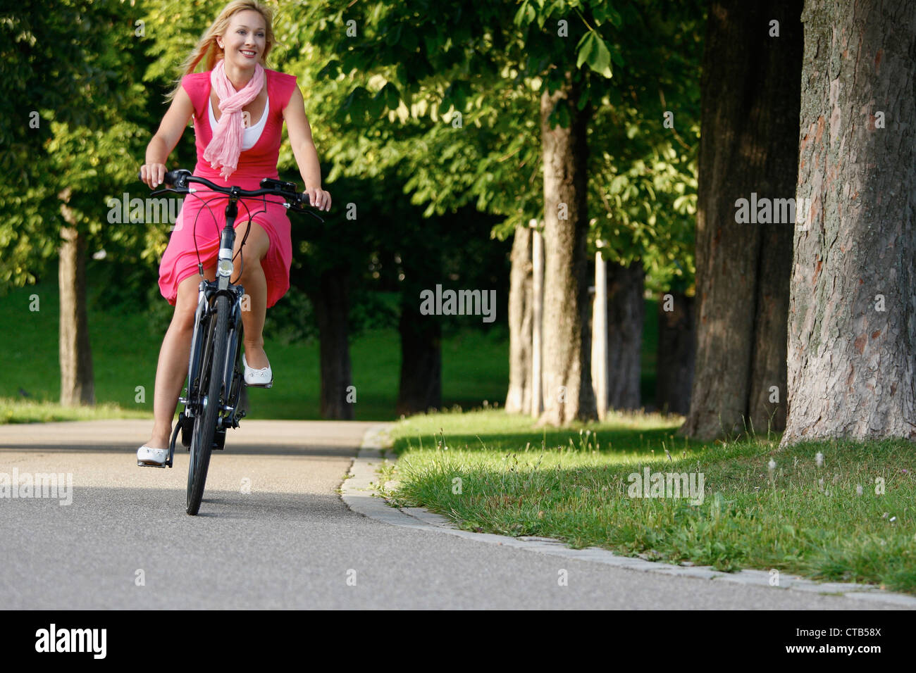 Woman cycling through Rosenstein Park, bike tour, Rosenstein Park, Stuttgart, Baden-Wurttemberg, Germany Stock Photo