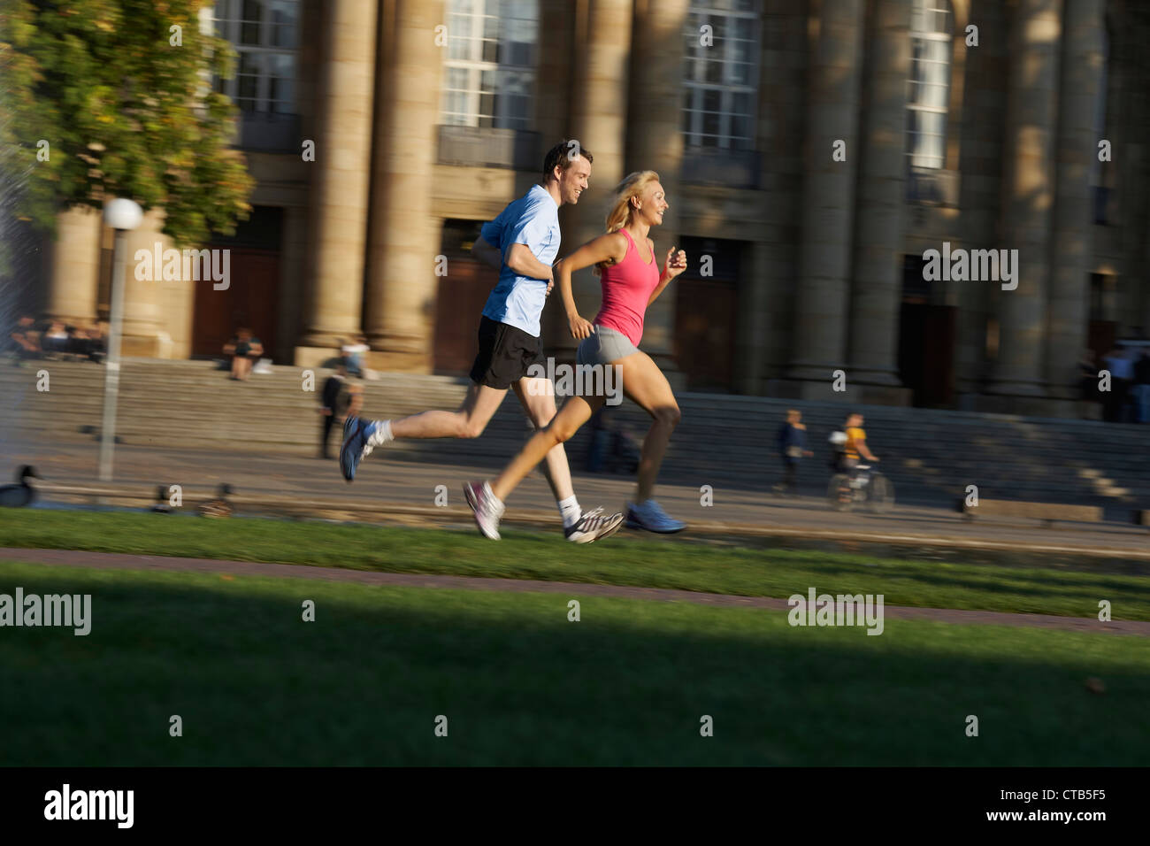 Young couple jogging, Upper Castle Gardena, Staatstheater, State Theater, Stuttgart, Baden Wurttemberg, Germany Stock Photo