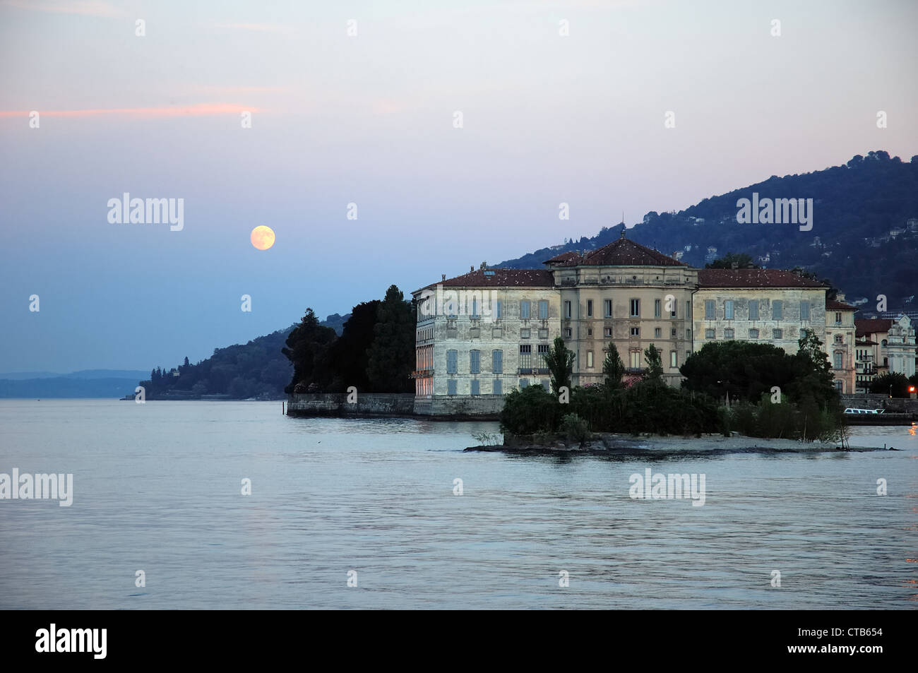 Moonrise over an antique italian villa on lake costline; Lago Maggiore