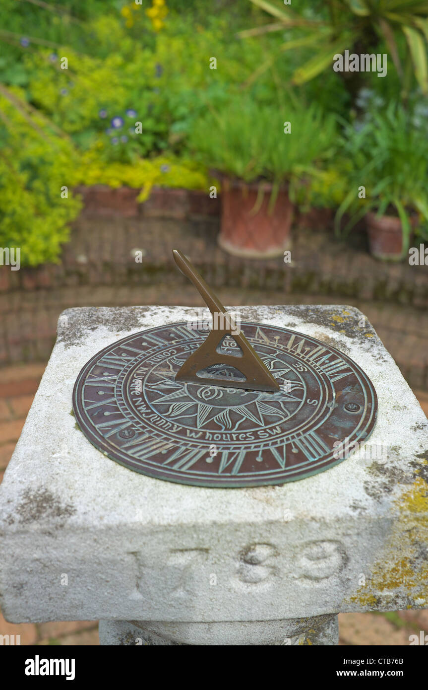 Garden sun dial on a brick patio, England, UK Stock Photo