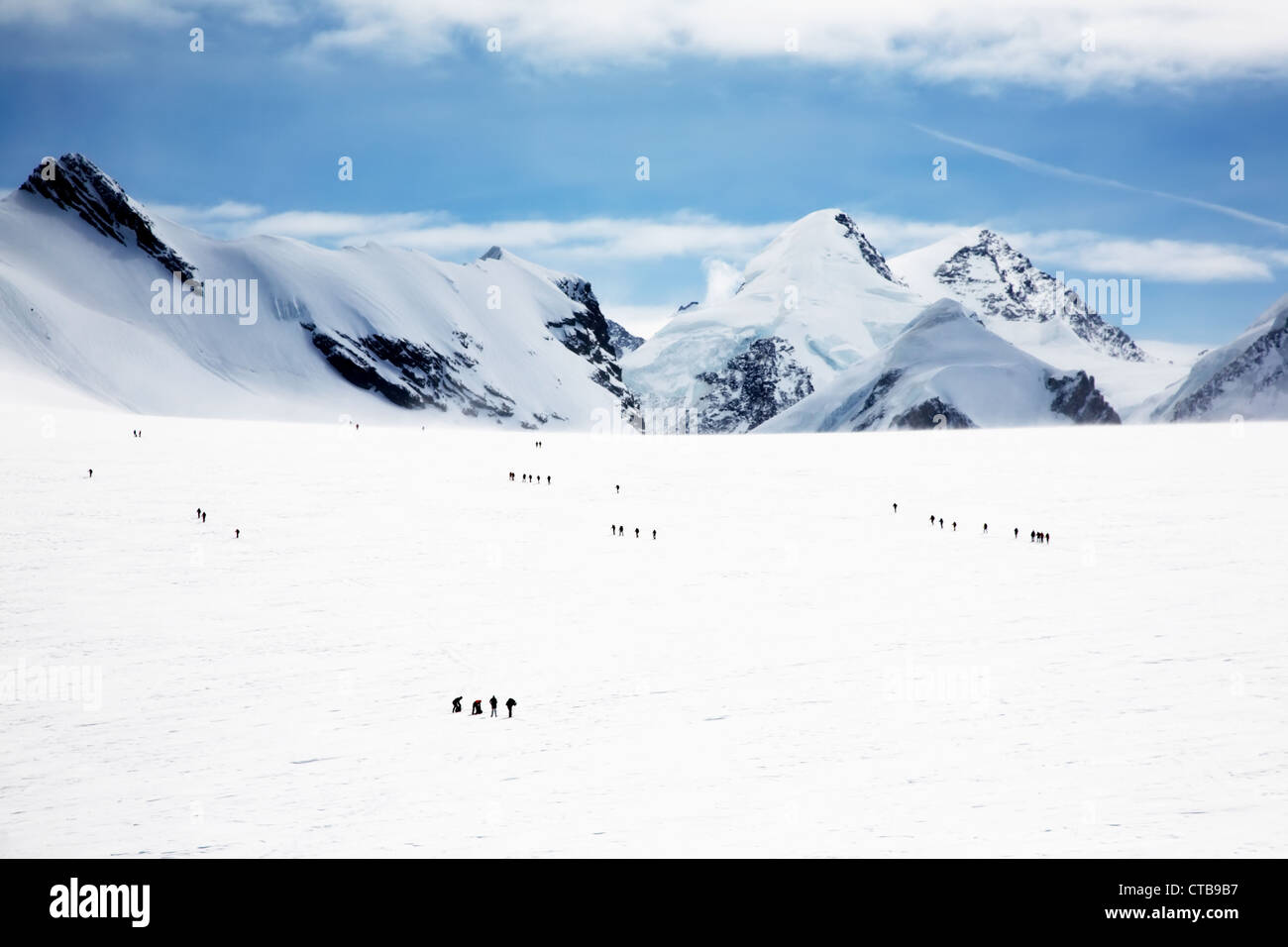 Groups mountaineers walking on big Verra Glacier in background peaks Castore Polluce MonteRosa Swiss-Italy border Stock Photo