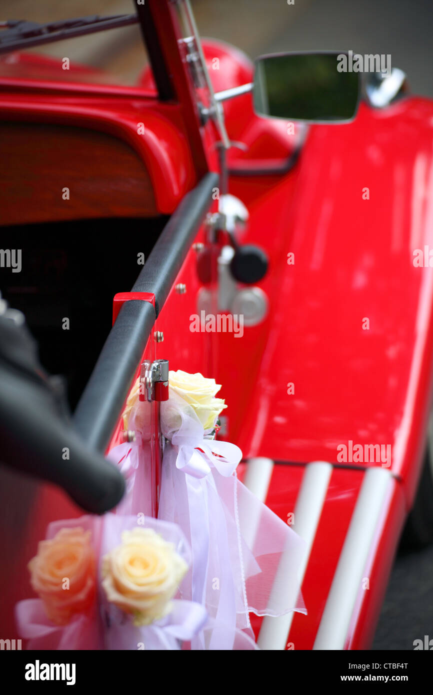 old red vintage car detail of red car door Bridal limousine handle with flower decorations Stock Photo