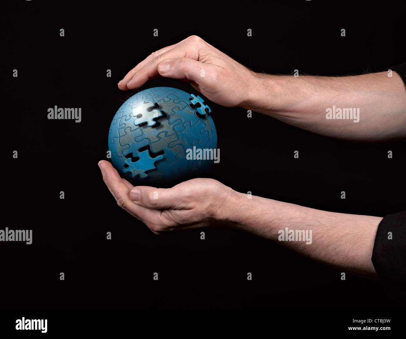 Man holding a glowing earth globe in his hands. Stock Photo