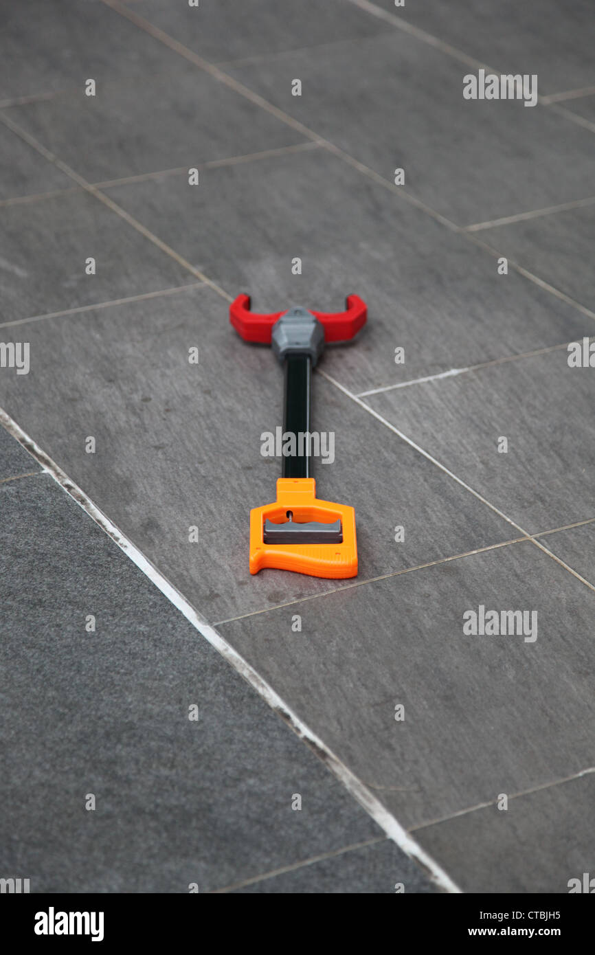 It's a photo of a toy for kid that is on the floor. It's a pliers or ...