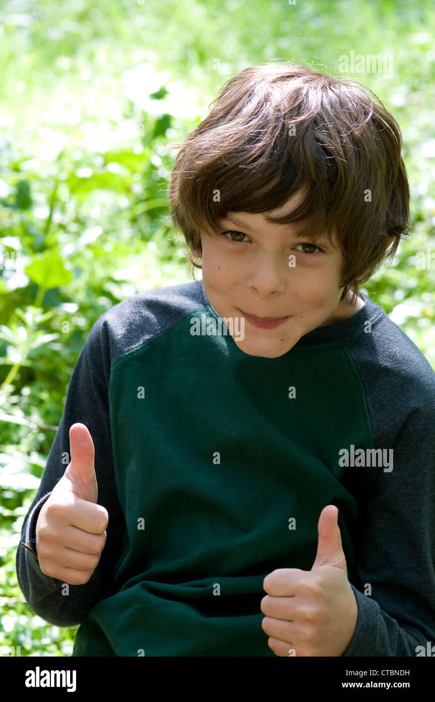 Portrait Of A Young Boy With Brown Hair Smiling With His Thumbs Up Stock Photo Alamy