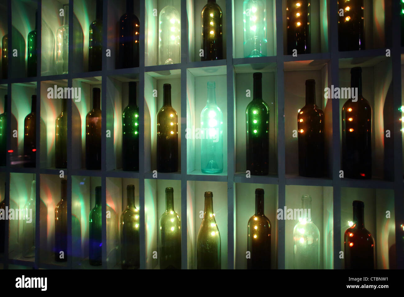 Liquor bottles in neon lit bottle shop window Stock Photo Alamy