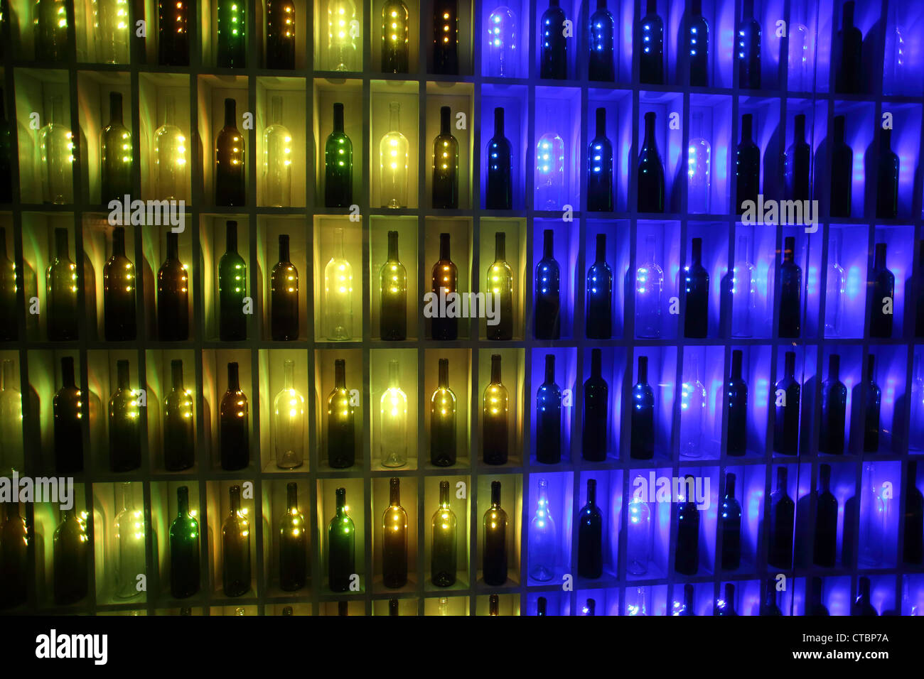 Liquor bottles in neon lit bottle shop window Stock Photo Alamy