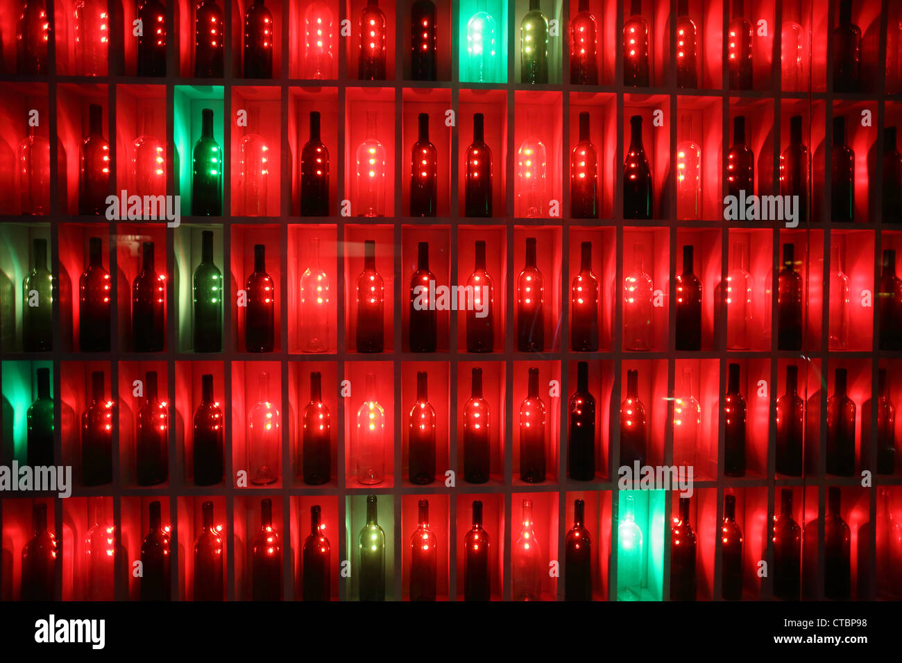 Liquor bottles in neon lit bottle shop window Stock Photo Alamy