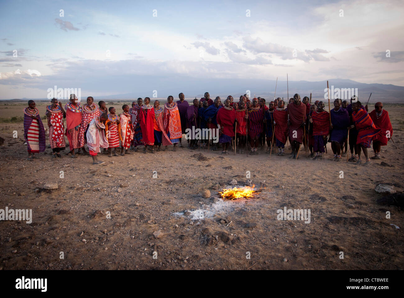 A Maasai Tribe gathers around the fire before a dance ceremony Stock Photo