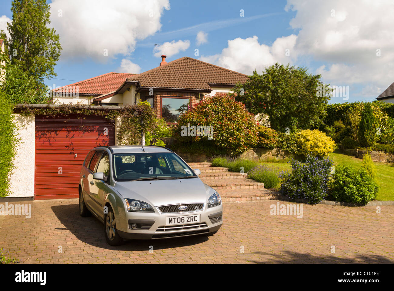 Car parked on bungalow driveway Stock Photo