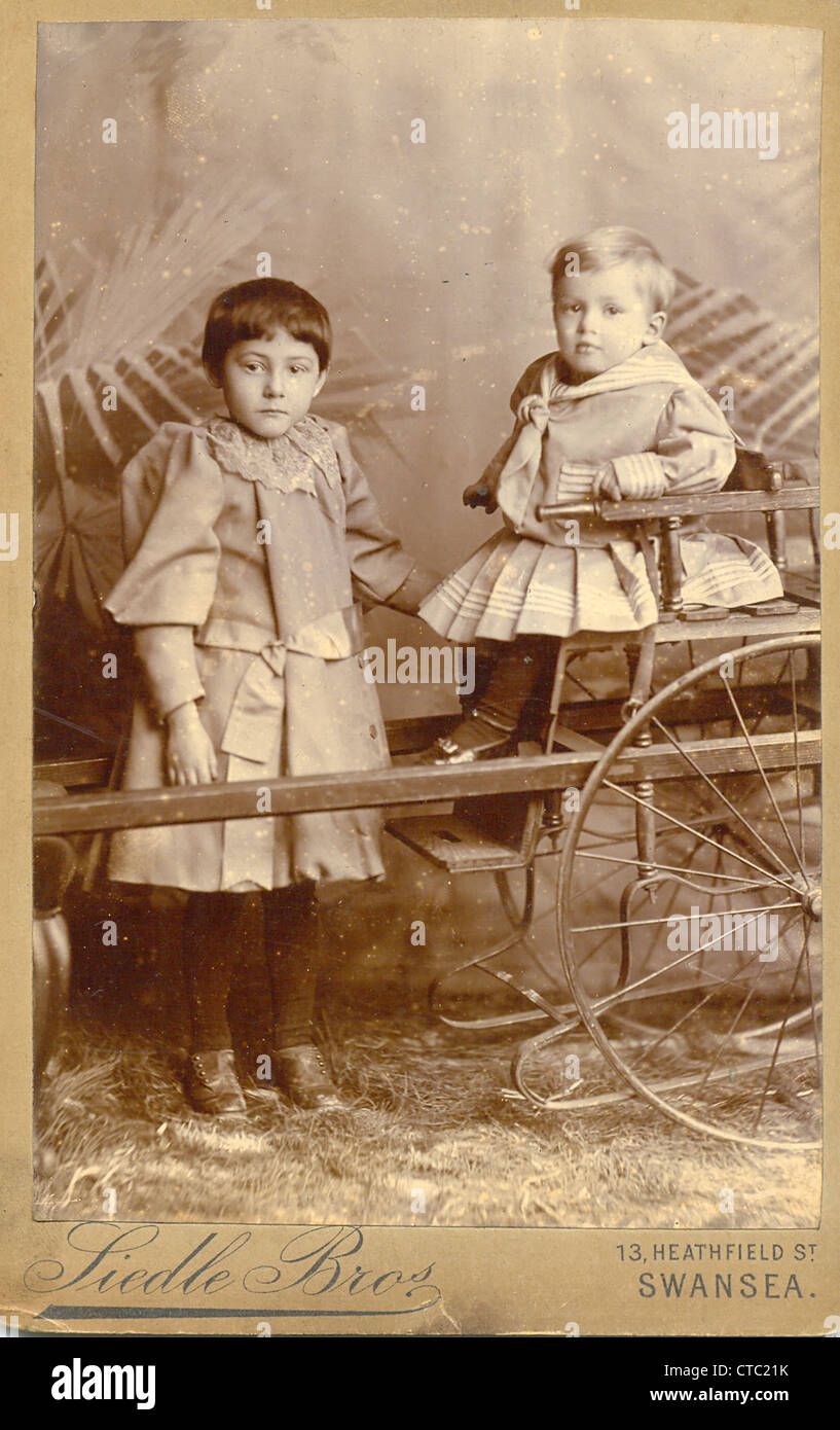 Cabinet portrait of siblings with cart Stock Photo