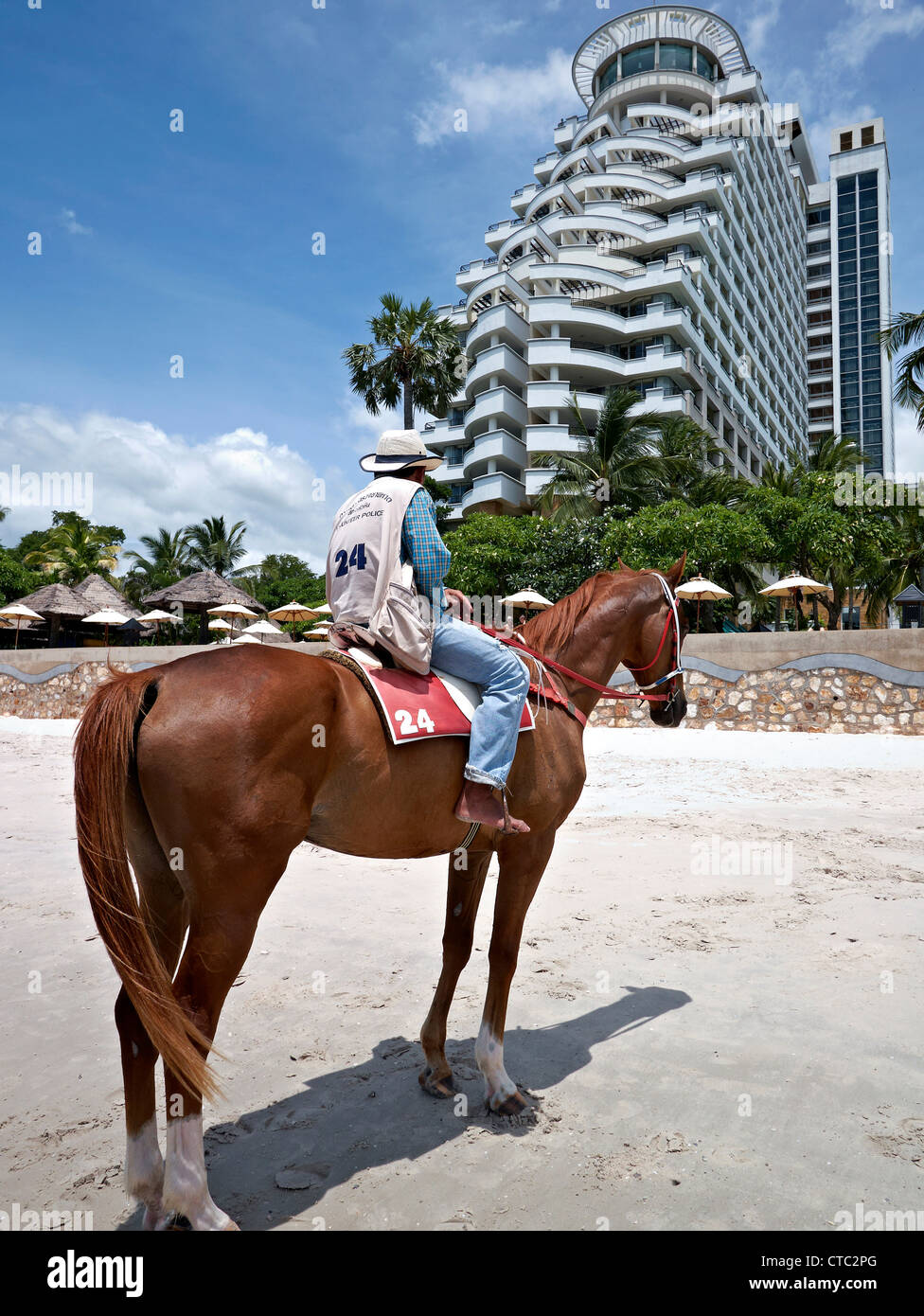 Horse And Rider On Hua Hin Beach With The Hilton Hotel Resplendent