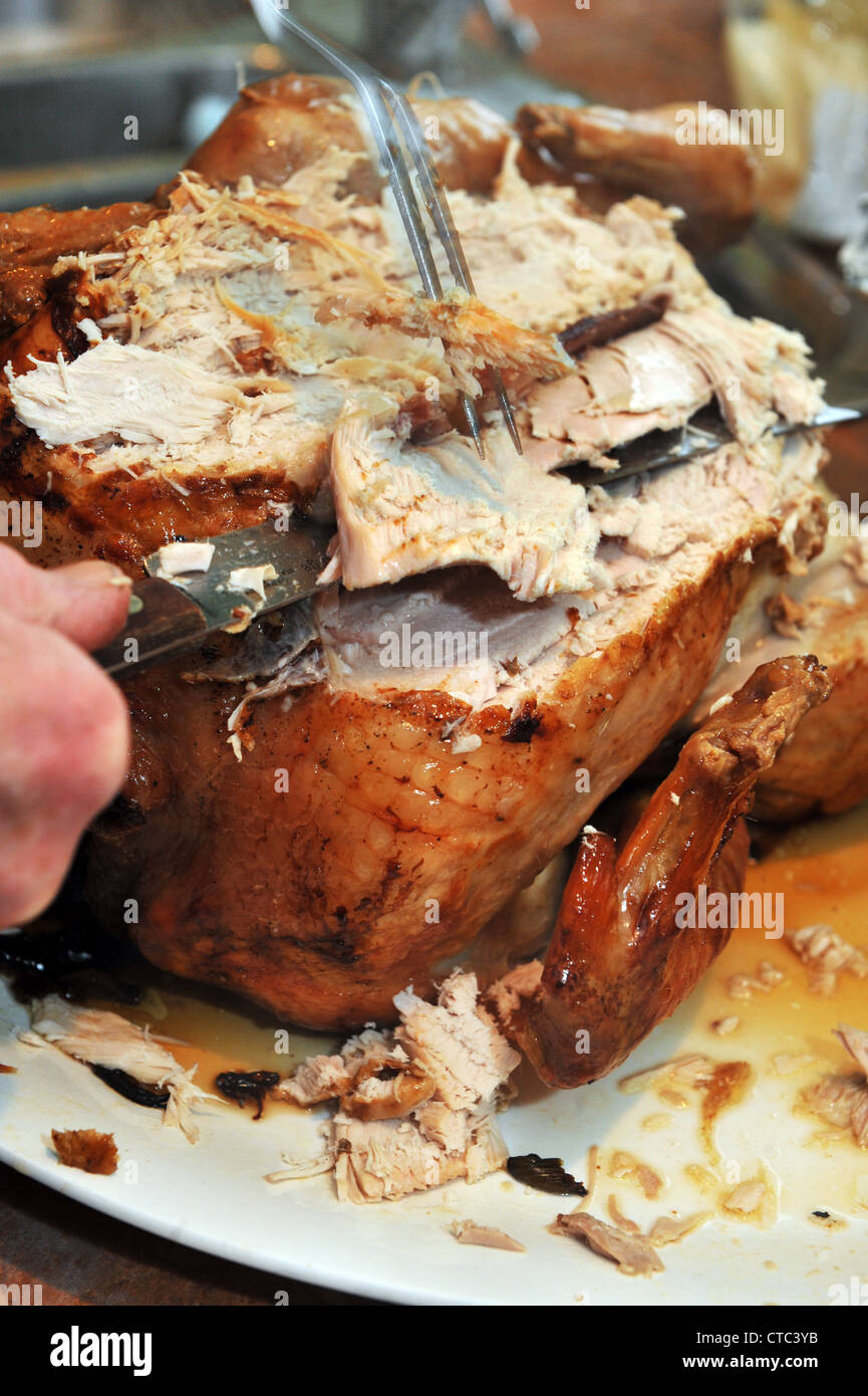 Traditional turkey Christmas dinner, carving the meat. Stock Photo