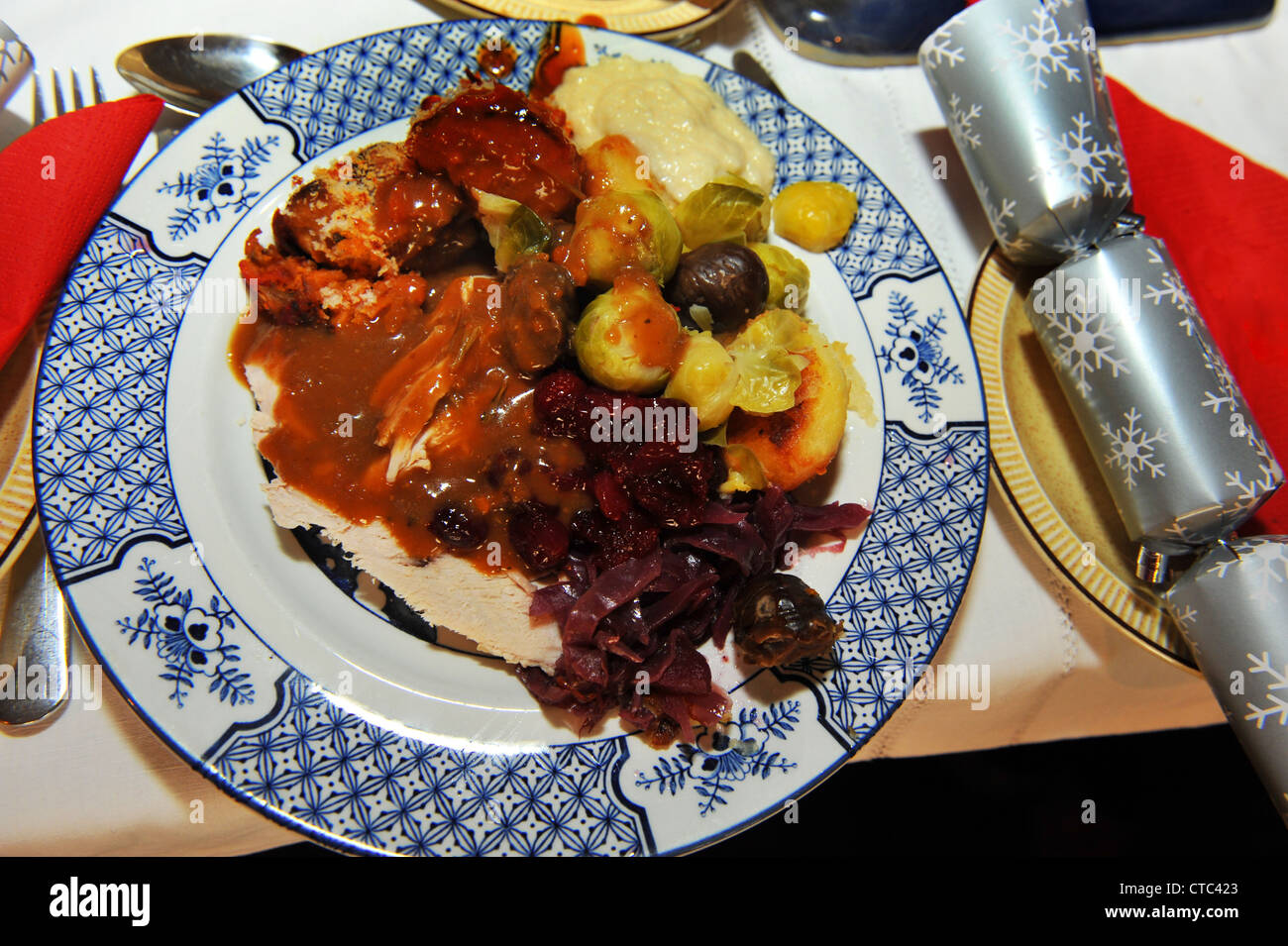 Traditional turkey Christmas dinner with sprouts, red cabbage, gravy bread sauce Stock Photo
