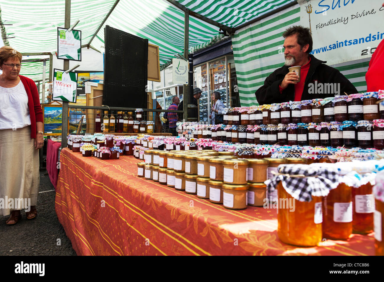 Market stall holder selling jam, jams & marmalade at Louth food