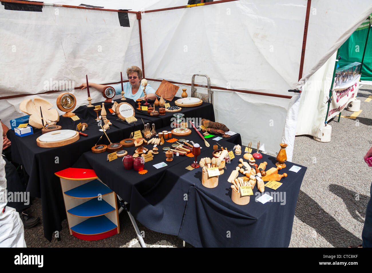 Market stall holder selling wood turned items at Louth food festival Lincolnshire, UK, England