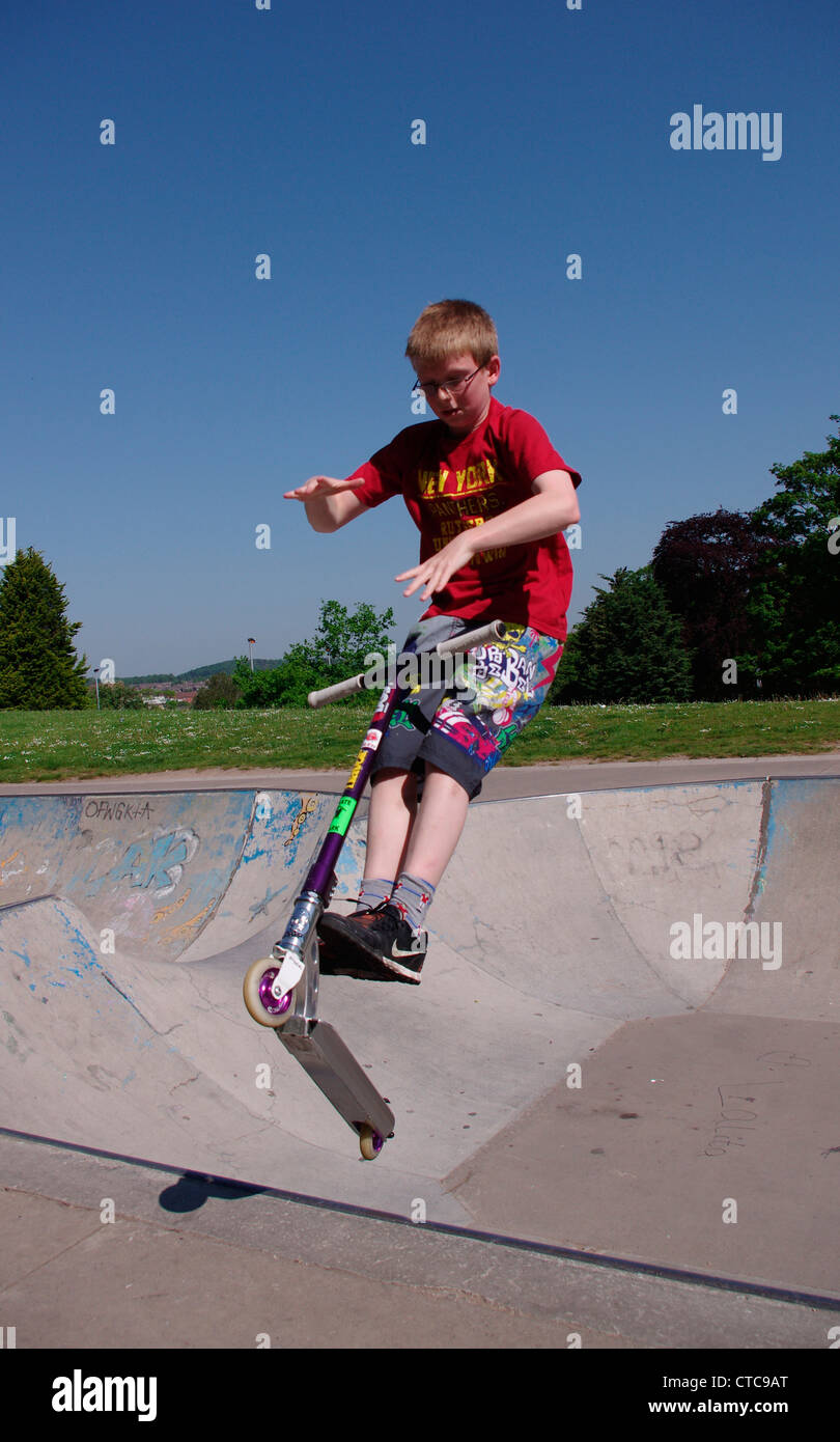 Boy on scooter doing trick Stock Photo Alamy