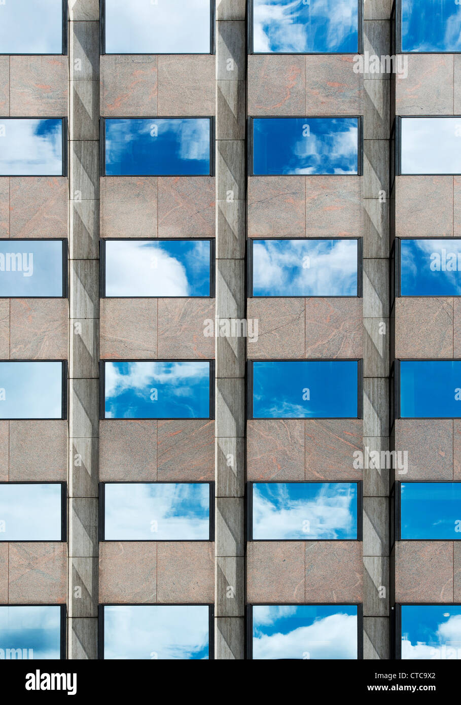 Blue sky and clouds reflected in Office block glass windows. London Stock Photo