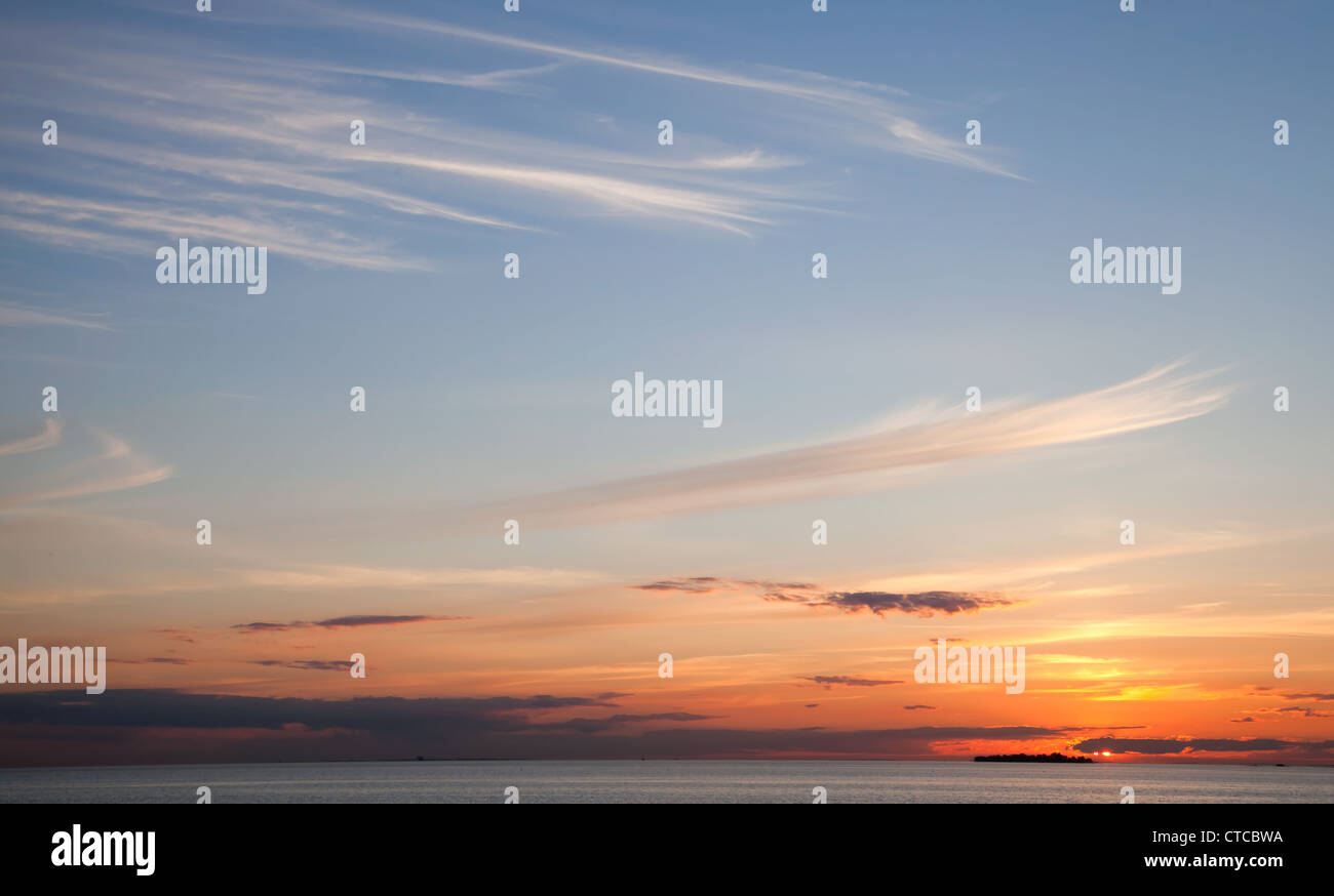 Sea coastal background with windy clouds at the sunset Stock Photo