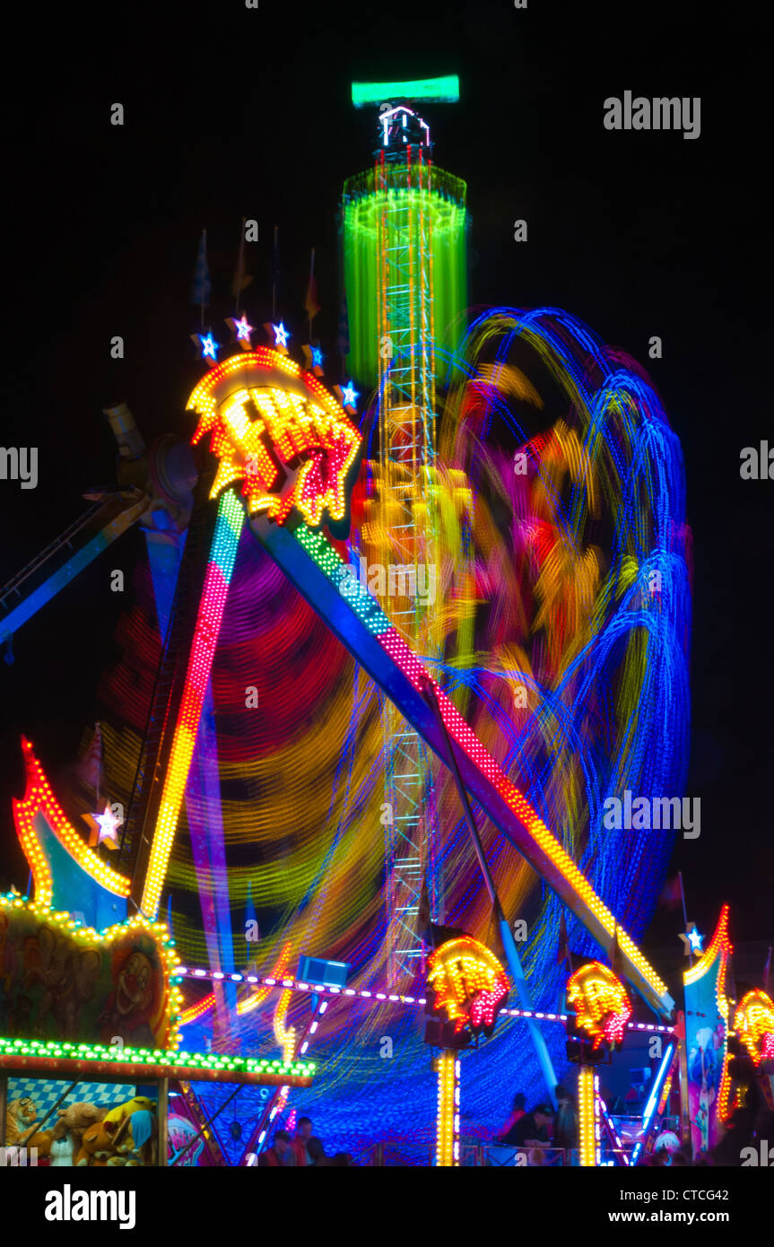 Night shots of lighted amusement rides at the Munich Oktoberfest, Munich, Germany Stock Photo
