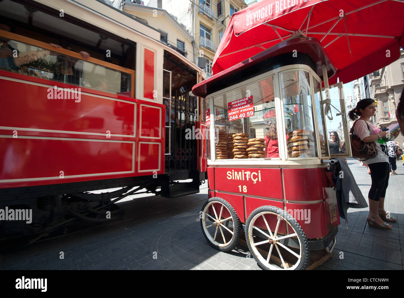ISTANBUL, TURKEY. A simit cart and tram on Istiklal Caddesi in the Beyoglu district of the city. 2012. Stock Photo