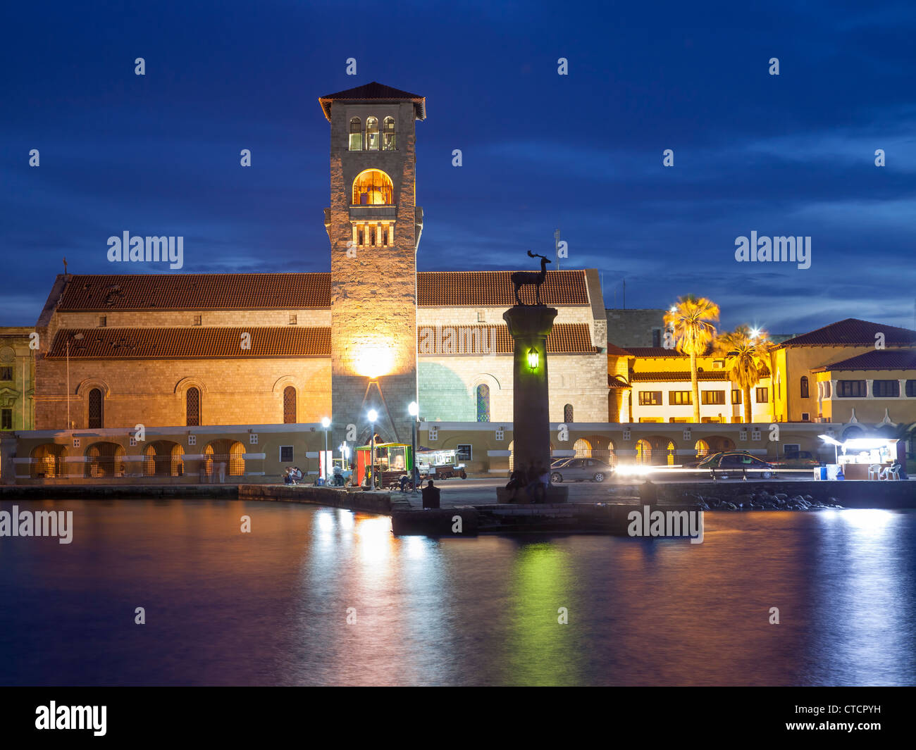Entrance to Mandraki Harbour at night, Rhodes Greece Stock Photo