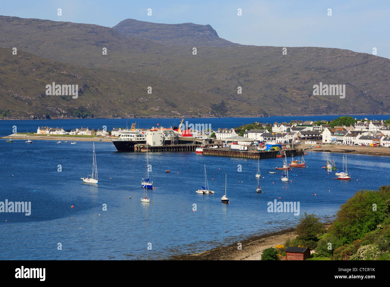 View to fishing port on Loch Broom with ferry in dock on North Coast 500 route at Ullapool Wester Ross Ross and Cromarty Scotland UK Stock Photo