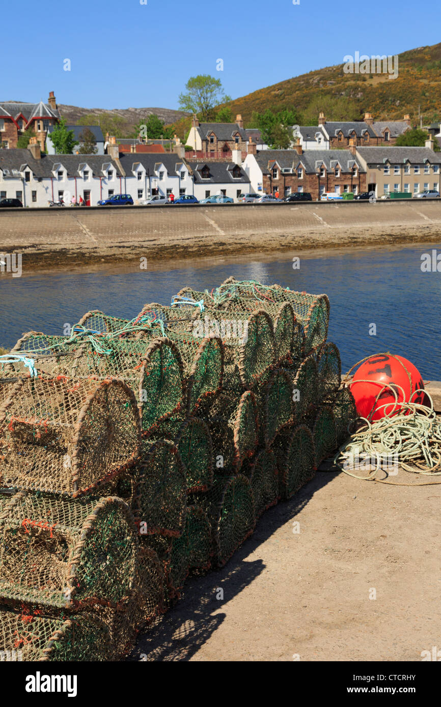 Lobster pots on quayside in fishing harbour on Loch Broom on northwest highlands coast Ullapool Wester Ross Highland Scotland UK Stock Photo