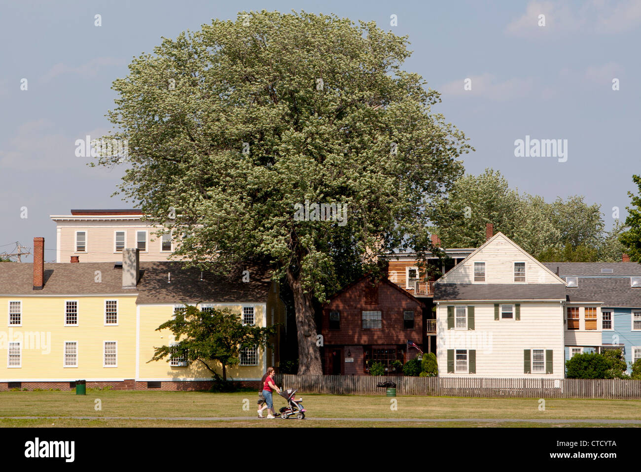People walking through a public park bordered by residential housing, Salem, Massachusetts