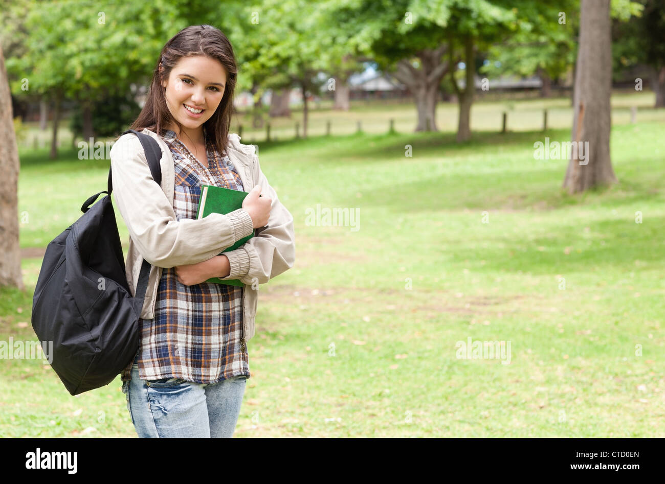 Young student holding textbook Stock Photo - Alamy