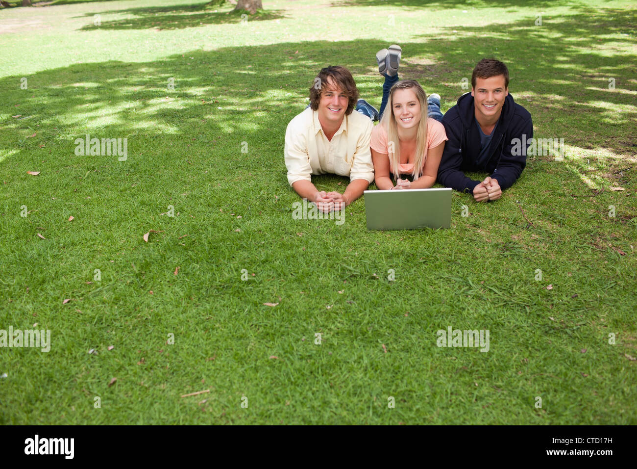 Three smiling students looking at camera Stock Photo - Alamy