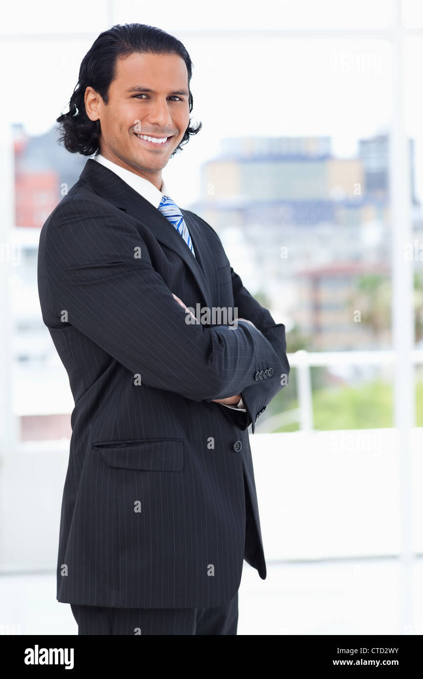 Smiling executive crossing his arms while looking at the camera Stock ...
