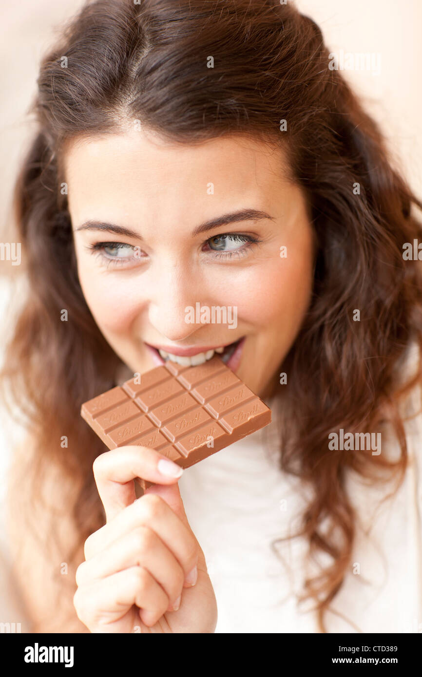 Woman eating chocolate Stock Photo