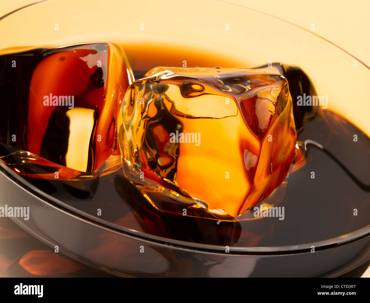 Close up of ice cubes floating in a glass of cola Stock Photo - Alamy