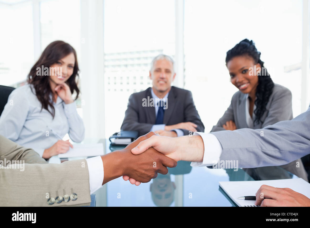 Two executives shaking hands during a meeting Stock Photo