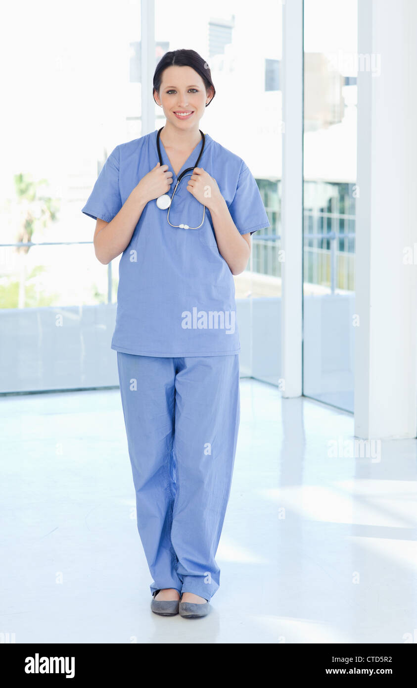 Smiling medical intern wearing a blue short-sleeve uniform Stock Photo