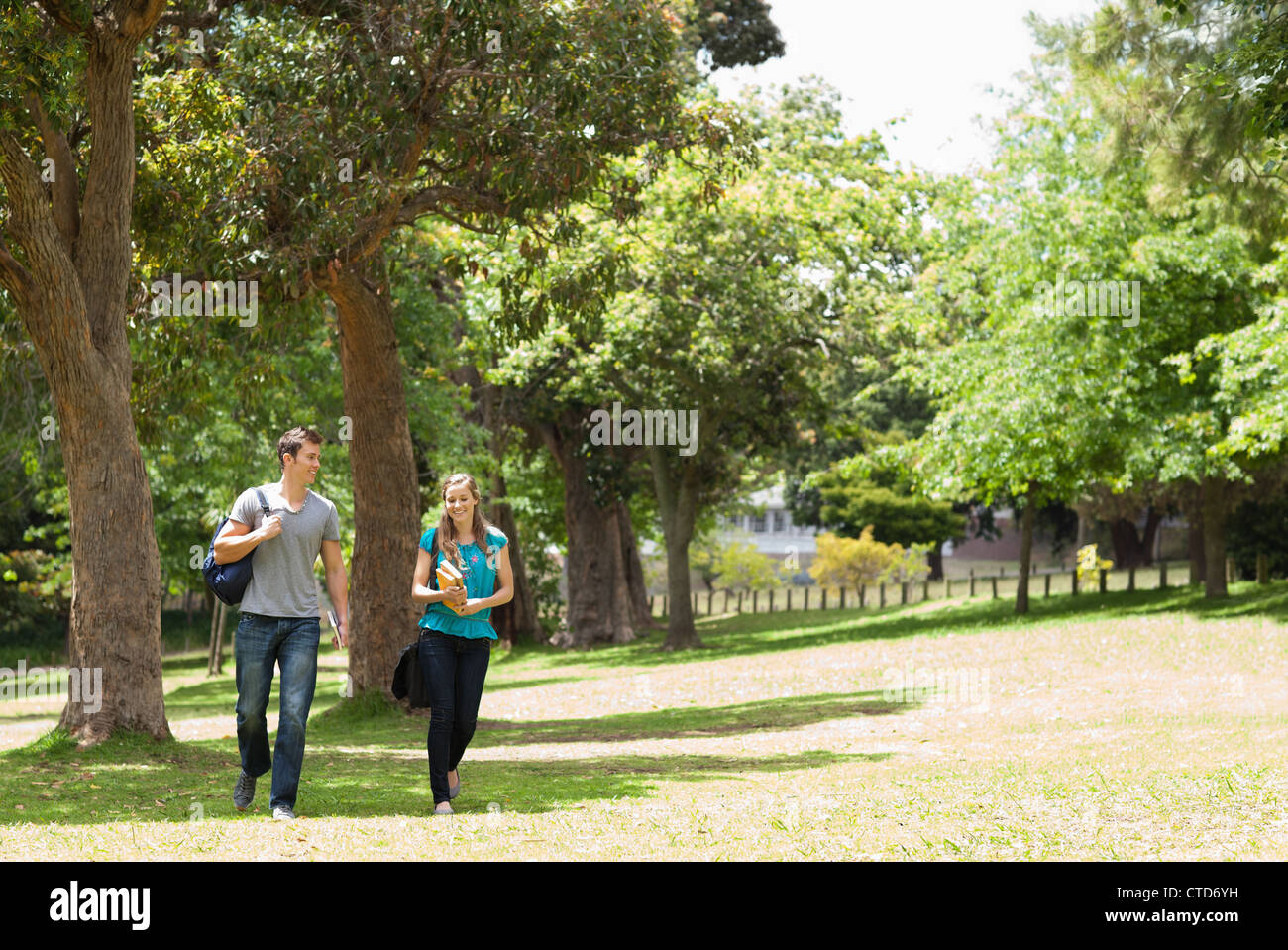 Couple of student walking Stock Photo - Alamy