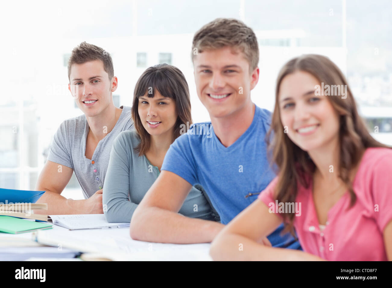 Side view of four students looking towards the camera Stock Photo - Alamy