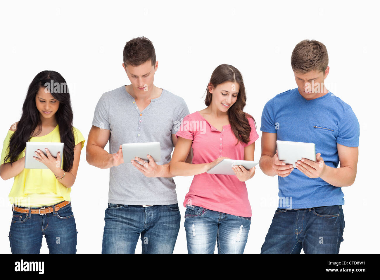A group standing beside each other and using their tablet pc's Stock Photo