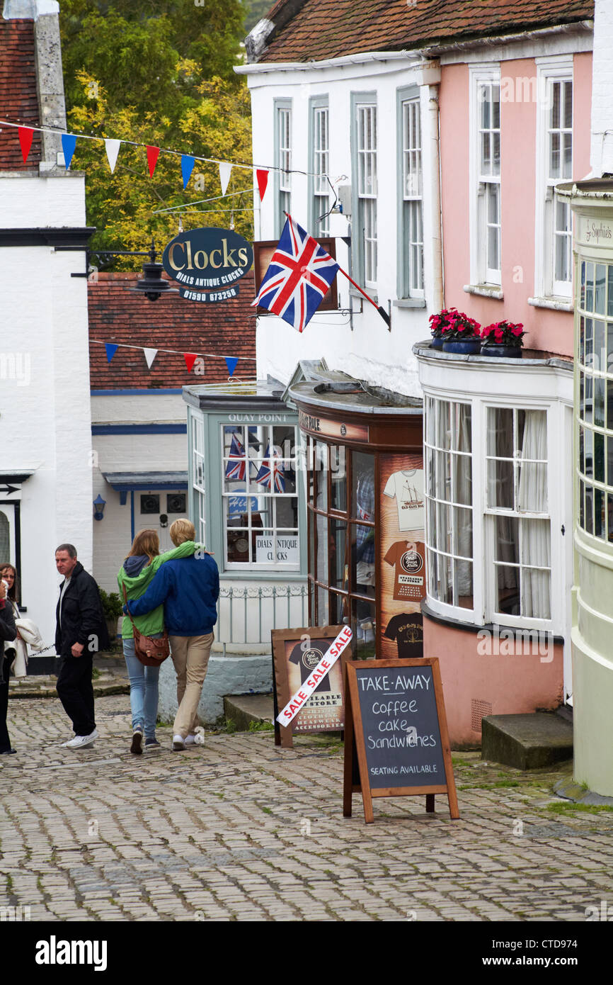 tourists explore cobbled street and shops at Quay Hill, Lymington, Hampshire UK in July Stock Photo