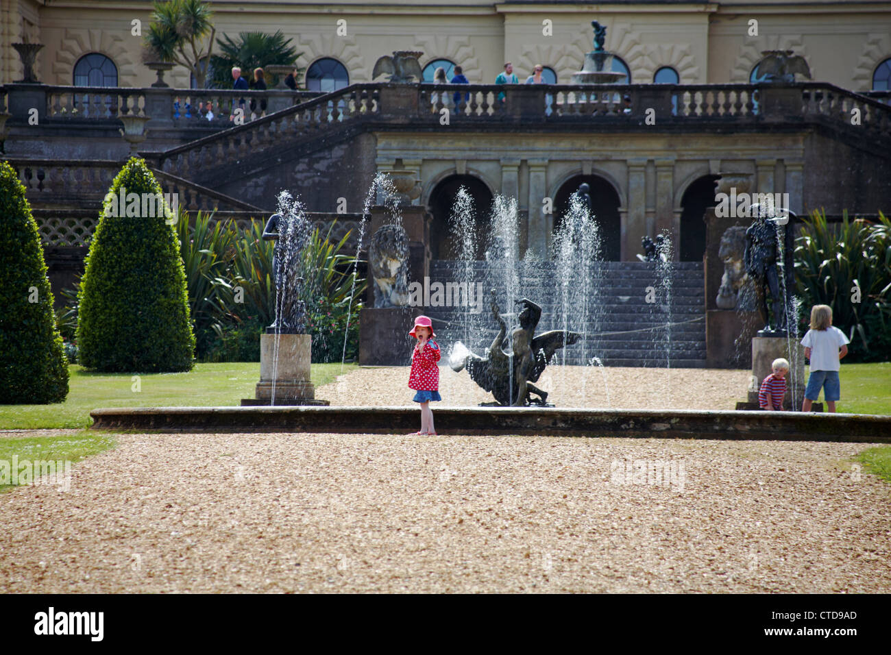 children having fun by the fountains in the gardens of Osborne House, Isle of Wight, Hampshire, UK in June Stock Photo