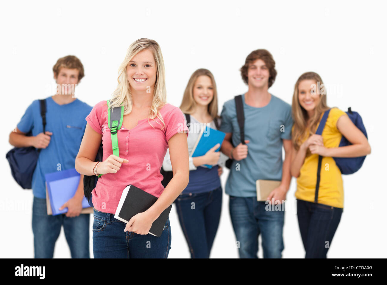 Smiling group stand together with one girl standing in front Stock Photo