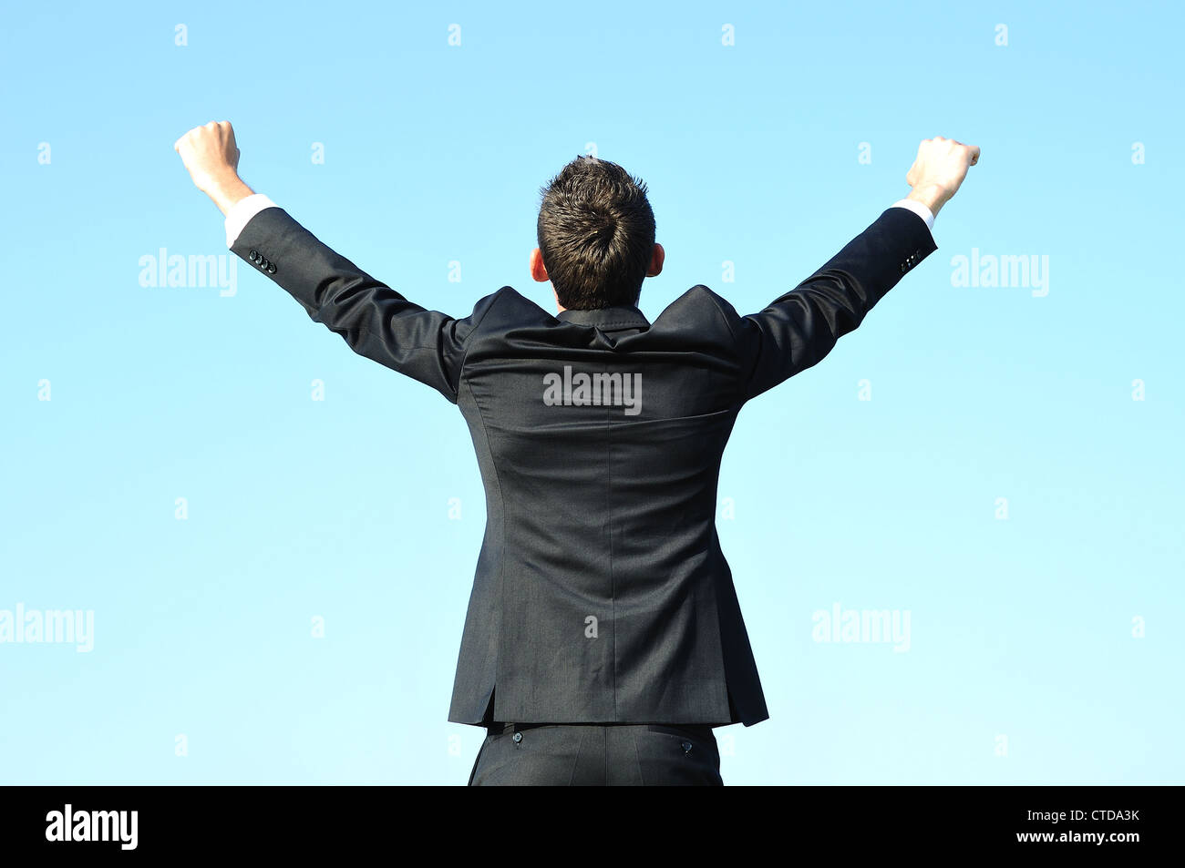 Business man happy on sky Stock Photo - Alamy