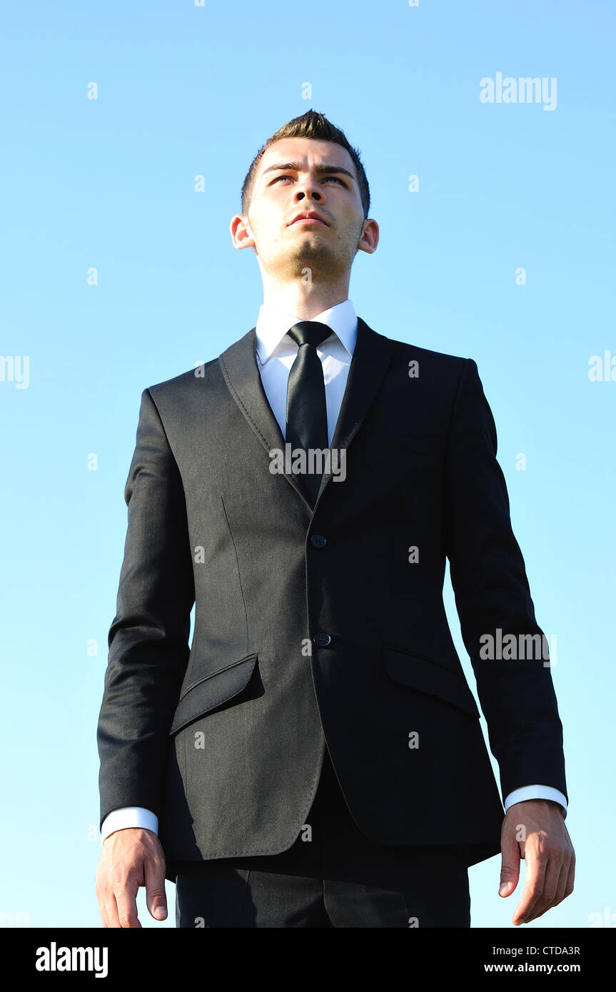 Business man standing on sky Stock Photo - Alamy