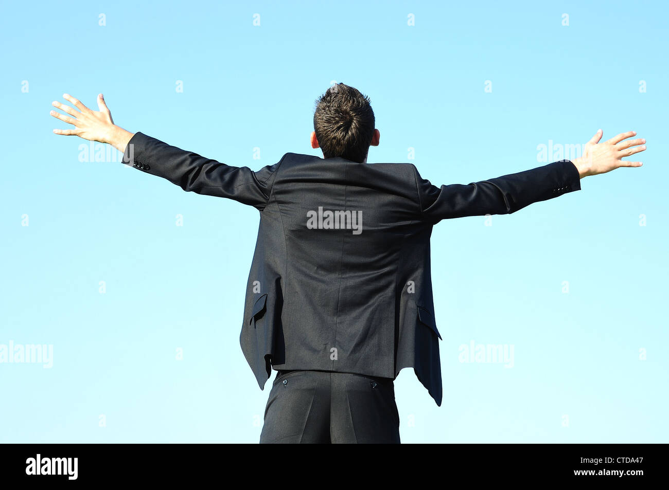 Business man happy on sky Stock Photo - Alamy